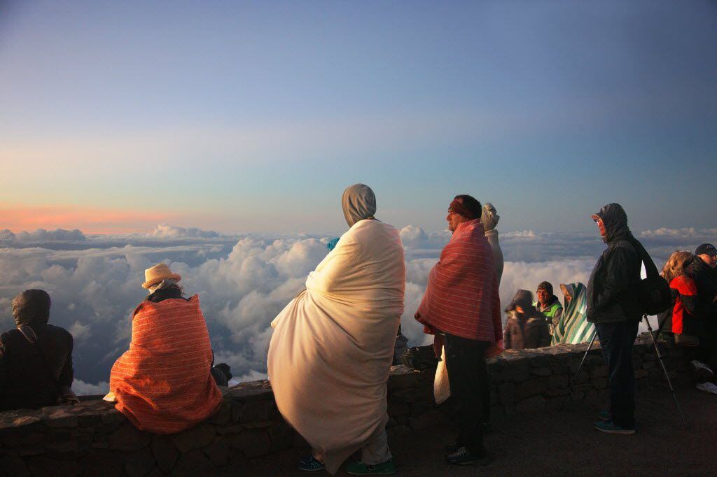 Visitors greet sunrise at the summit of the volcano at Haleakal  National Park in Maui. 