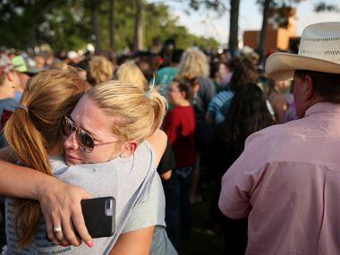 Mourners embrace during a vigil following a shooting at Santa Fe High School on May 18.