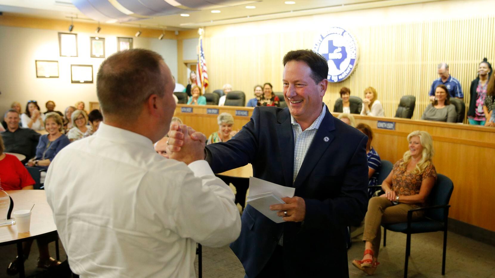 McKinney Independent School District superintendent Dr. Rick McDaniel (right) celebrated with Geoff Sanderson (left) after calling his name to celebrate his birthday other co-workers born in the month of September during a meeting at the McKinney ISD Administration Building in Dallas in 2018.