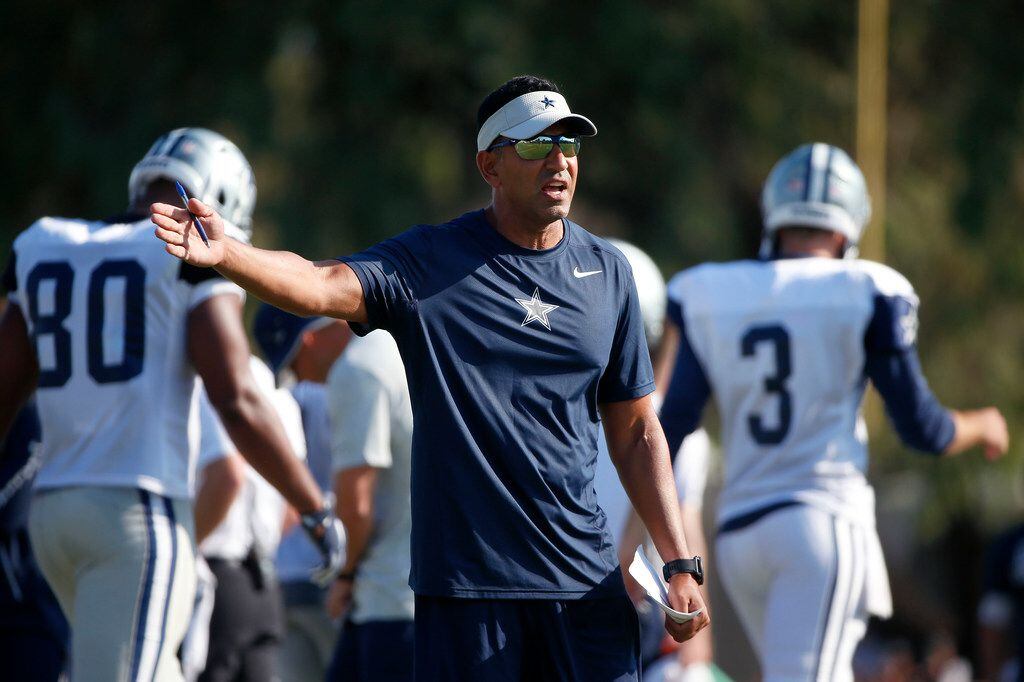 Dallas Cowboys wide receiver coach Sanjay Lal reacts after wide receiver K.D. Cannon runs in...