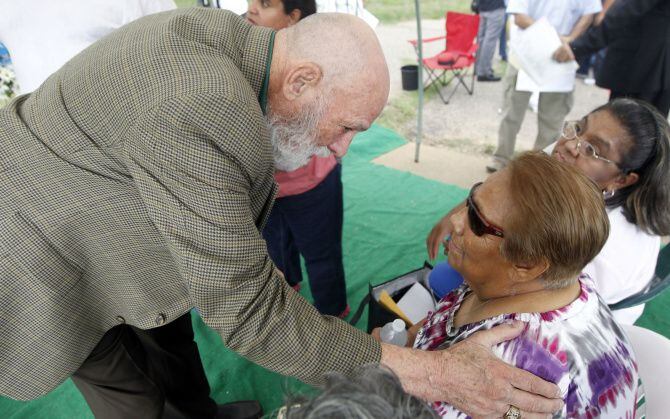 Retired Dallas police Officer Robert Rowe spoke with Bessie Rodriguez at a memorial at...