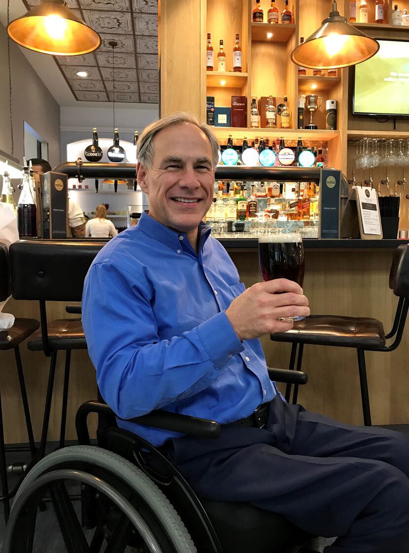 Texas Gov. Greg Abbott holds a pint of ale in the airport in Shannon, Ireland, on Friday,...