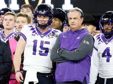 TCU Horned Frogs quarterback Max Duggan (15) and head coach Sonny Dykes can only watch from...