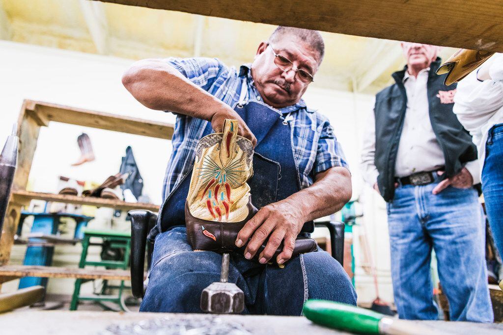 A craftsman in Mercedes, Texas works on a pair of boots for Dallas-based Miron Crosby, which...