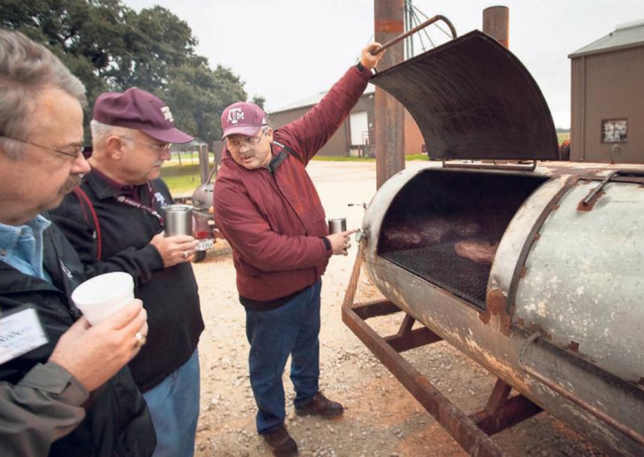 As Texas A&M professor Davey Griffin demonstrates, frequent monitoring of the smoker is part...