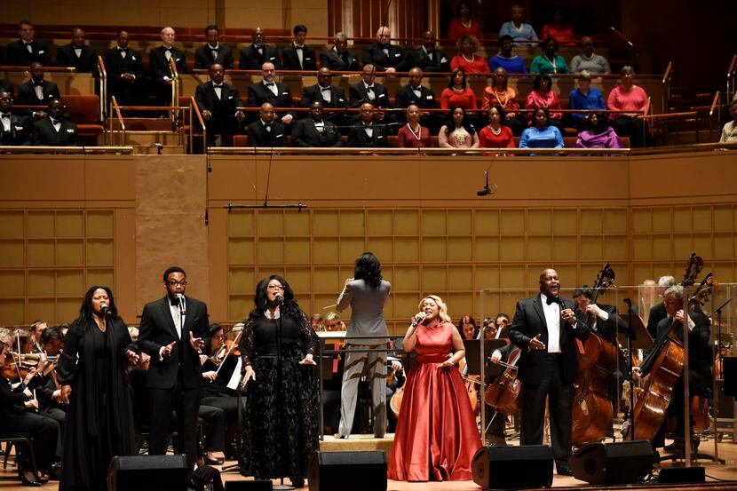 Singer DeShonda Rideout, right, and Bishop Marvin Winans, far-right, sing with the Dallas...