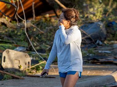 Maricela Chanaa reacts to seeing damage to her neighbors' houses caused by Sunday night's...