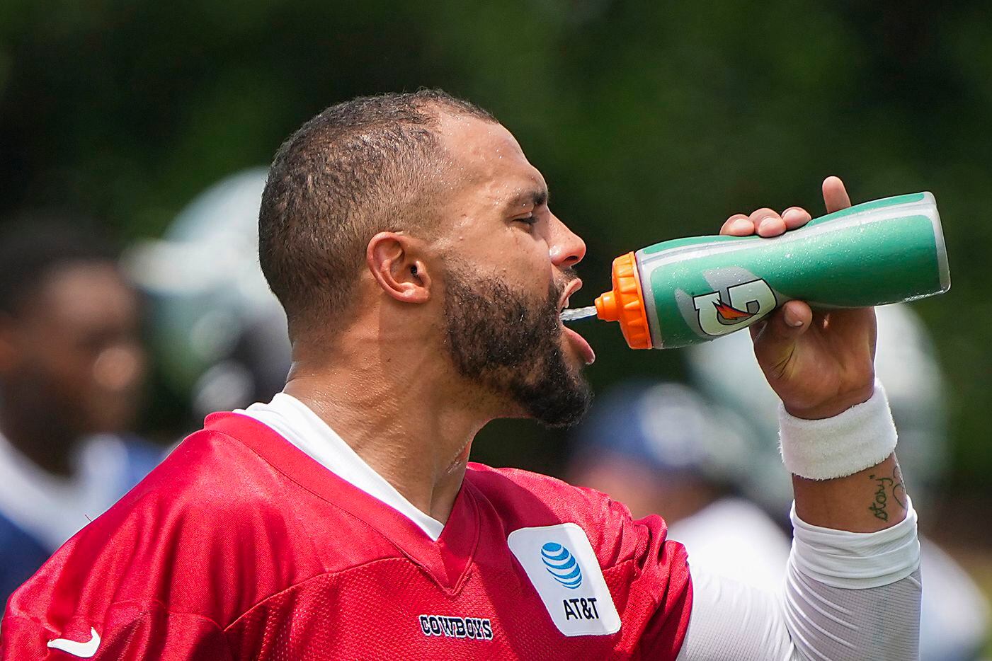 Dallas Cowboys quarterback Dak Prescott stays hydrated during a minicamp practice at The Star on Tuesday, June 8, 2021, in Frisco. (Smiley N. Pool/The Dallas Morning News)