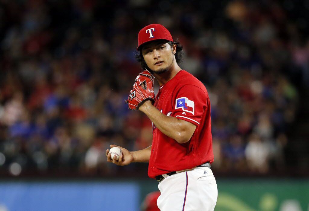 Texas Rangers' Yu Darvish of Japan looks to the plate before throwing to the Oakland...