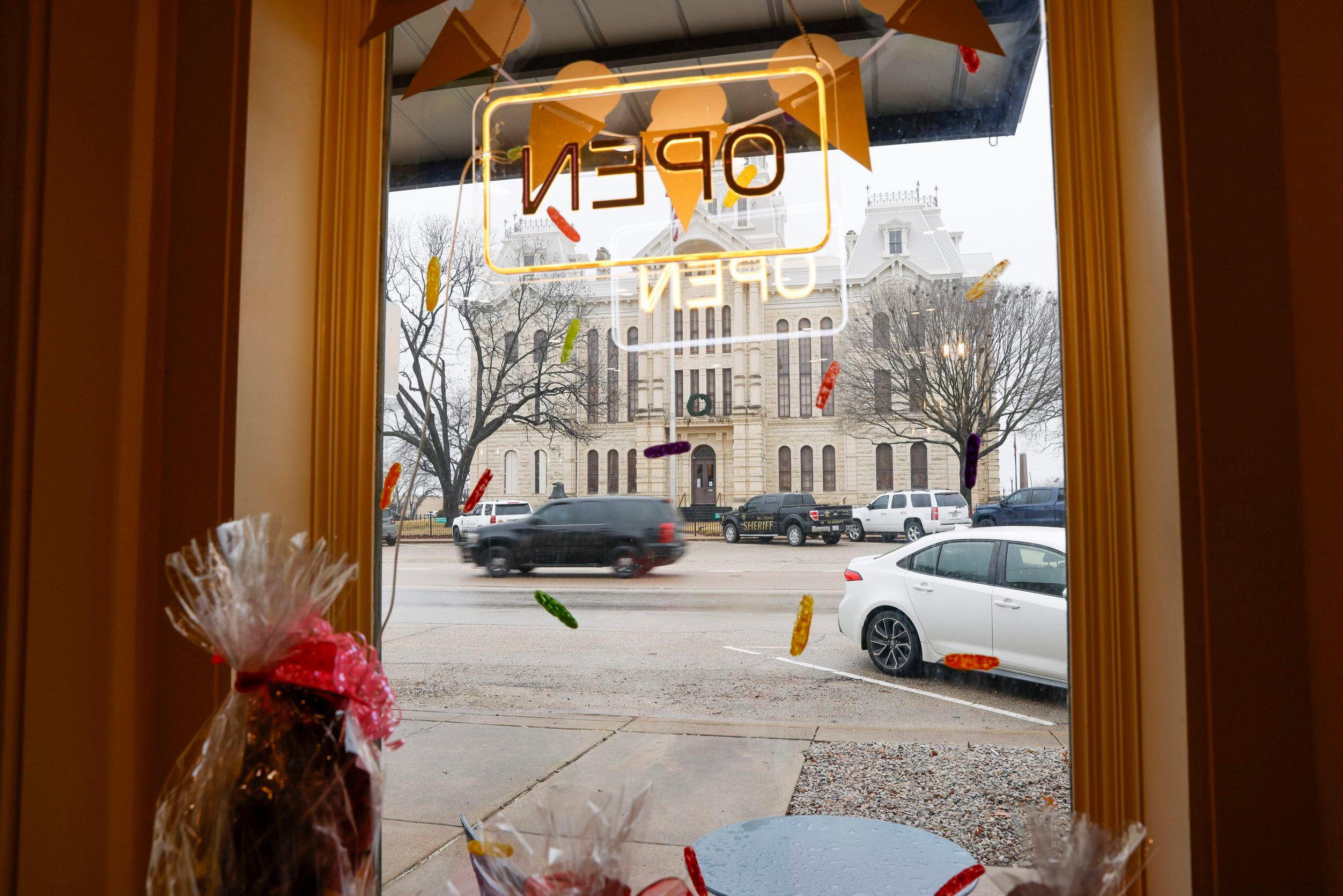 The Hillsboro County Courthouse is seen through the window of Sweet Joy Ice Cream and Candy...
