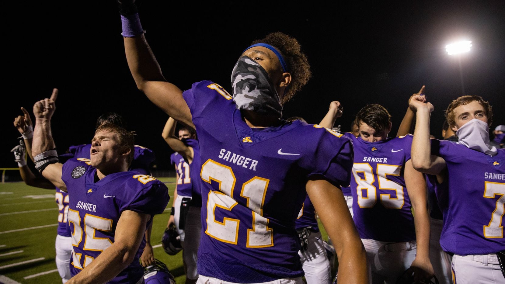 Sanger High School player CJ Flowers (21) celebrates with his team after winning against...