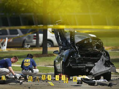 Members of the FBI Evidence Response team document the crime scene on May 4, 2015, outside...