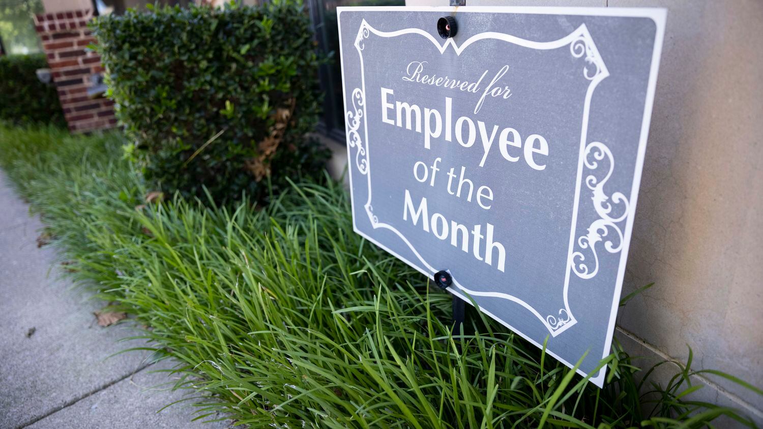 A reserved parking spot for the employee of the month is shown at the Black, Mann & Graham office in Flower Mound. Some people who are working from home are resisting a return to the office.