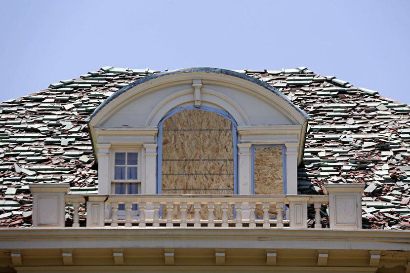 Tiles on a Swiss Avenue home show extensive damage Thursday, June 14, 2012 following severe...