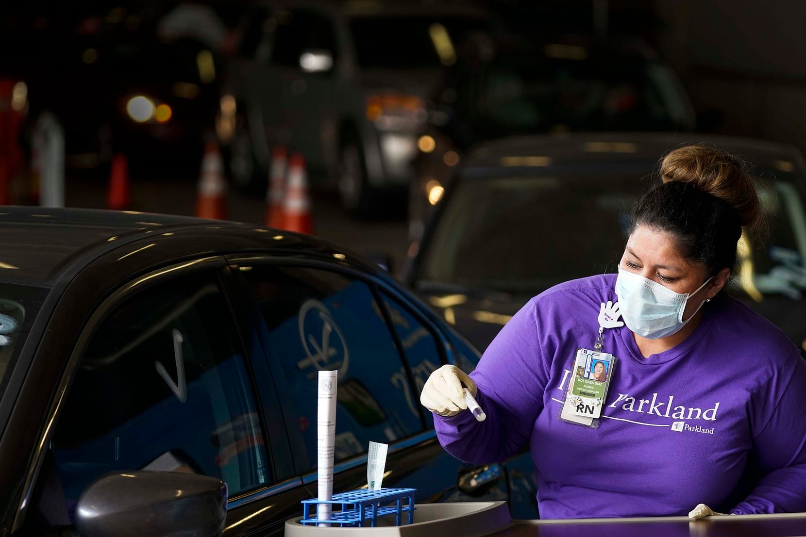 Parkland Homeless Outreach Medical Services (HOMES) program nurse manager Dolores Diaz prepares testing materials at a COVID-19 drive-through testing site at American Airlines Center on Monday, April 20, 2020, in Dallas. (Smiley N. Pool/The Dallas Morning News)