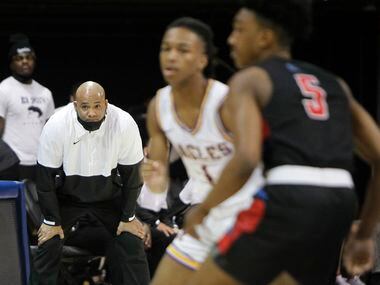 Duncanville head coach David Peavy intently follows the final minute of play in their 68-49...