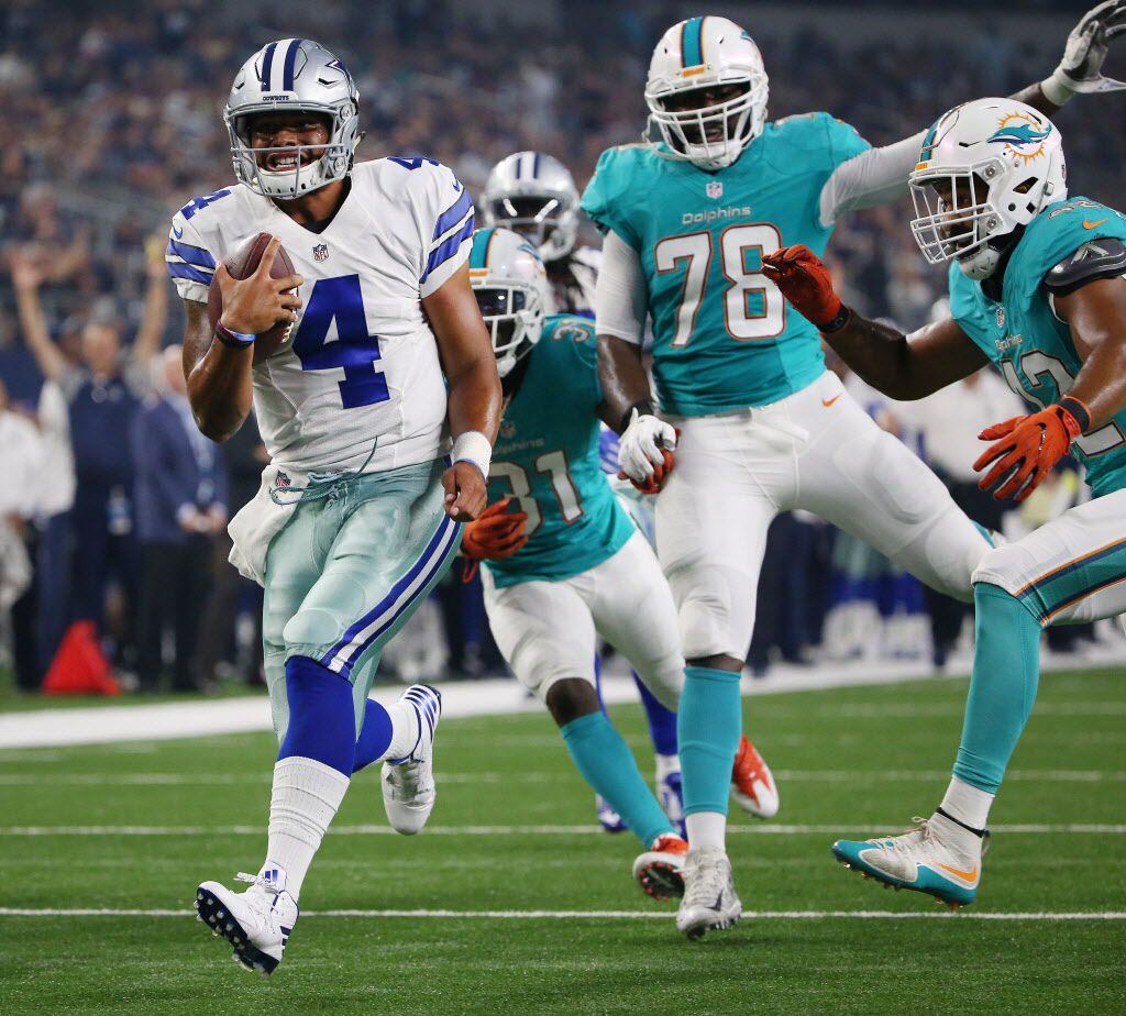 Dallas Cowboys quarterback Dak Prescott (4) scores a rushing touchdown to make the score...