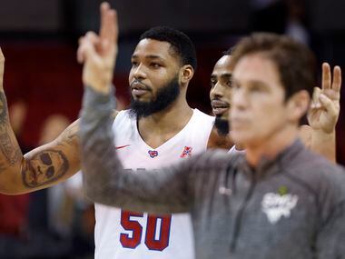 Southern Methodist Mustangs forward Marcus Weathers (50) and head coach Tim Jankovich listen to the school song after the in over the South Florida Bulls at Moody Coliseum in University Park, Texas, January 12, 2022. SMU won, 77-65 .