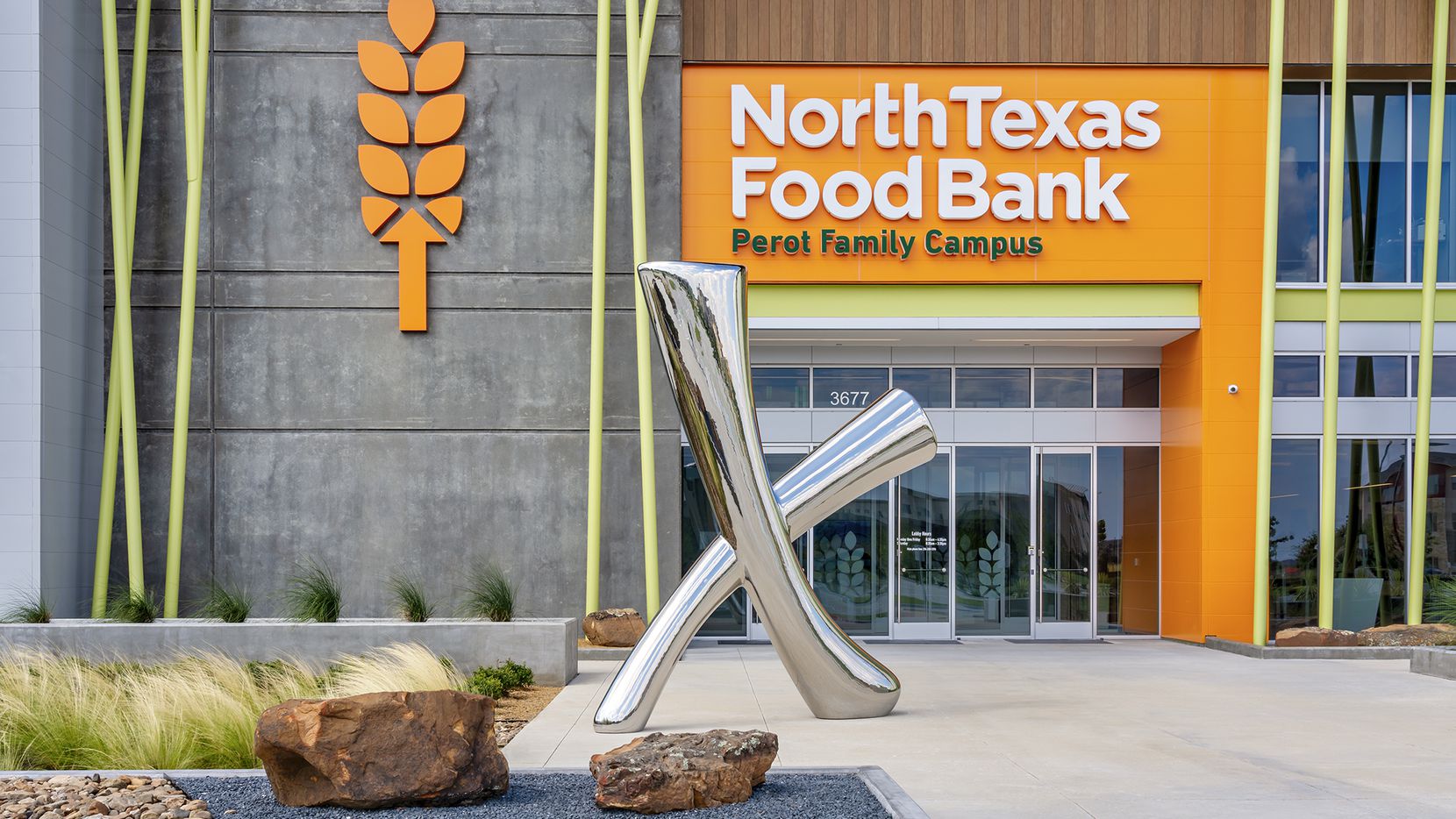 Exterior view of the new North Texas Food Bank facility with a large X sculpture out front.