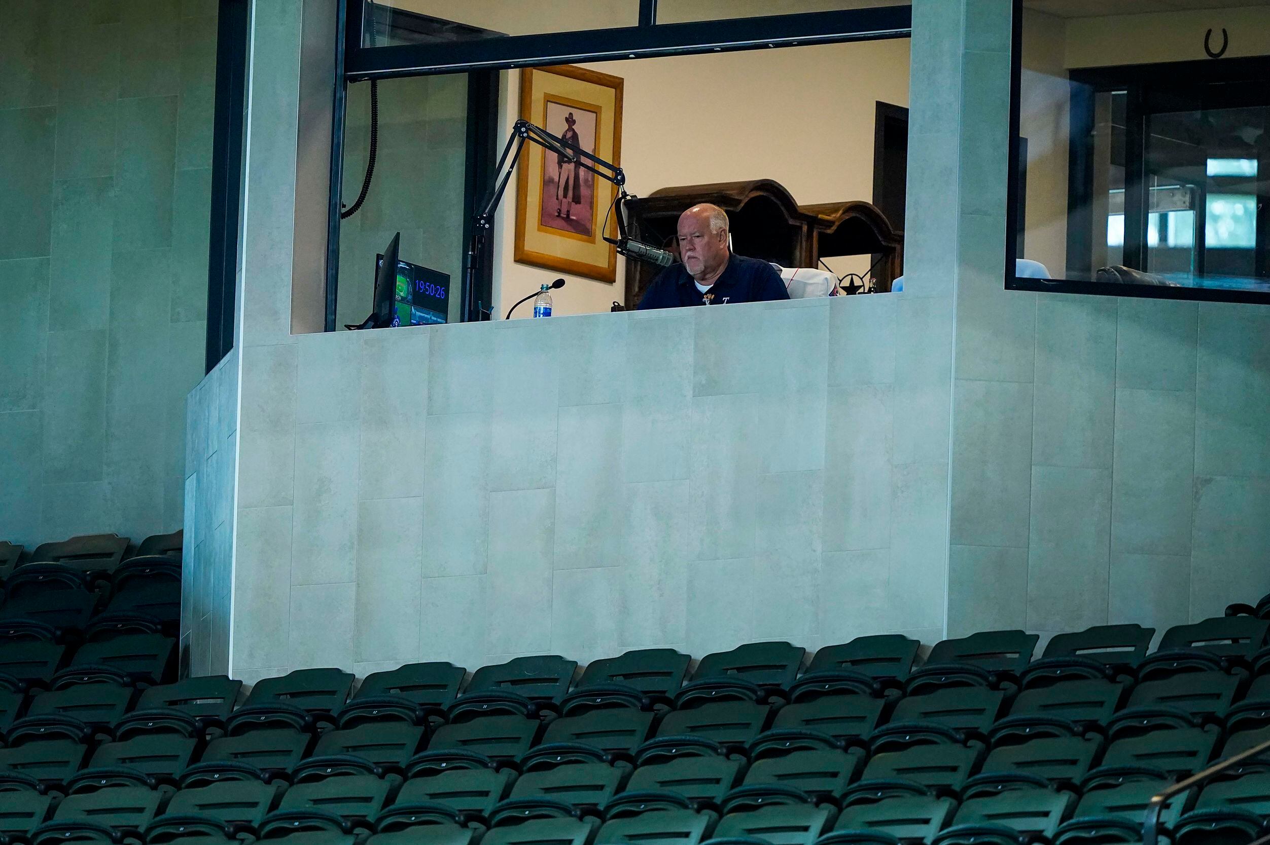 Announcer Chuck Morgan works in his booth during Texas Rangers Summer Camp at Globe Life...