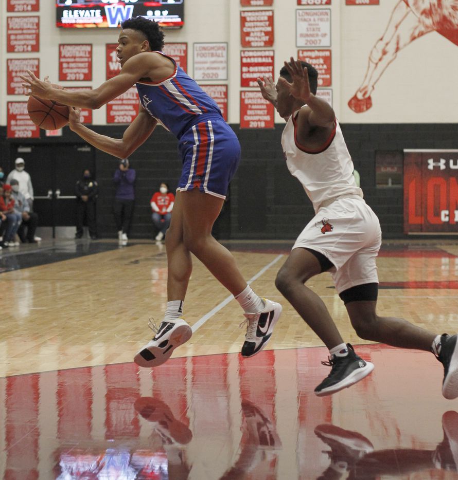 Duncanville guard Evan Phelps (2) , left, passes to a teammate as he is defended by Cedar Hill's Jalen Ware-Williams (1) during first half action. The two teams played their District 11-6A boys basketball game at Cedar Hill High School in Cedar Hill on January 14, 2022. (Steve Hamm/ Special Contributor)