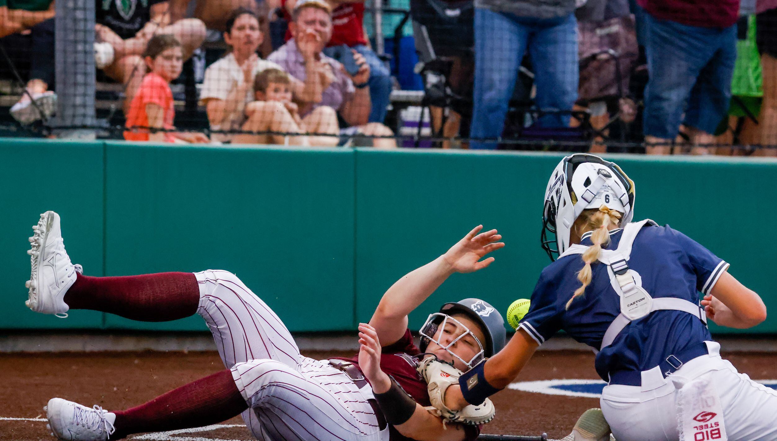Frisco Heritage right fielder Maddy Garza (10) slides into home plate, earning the only...