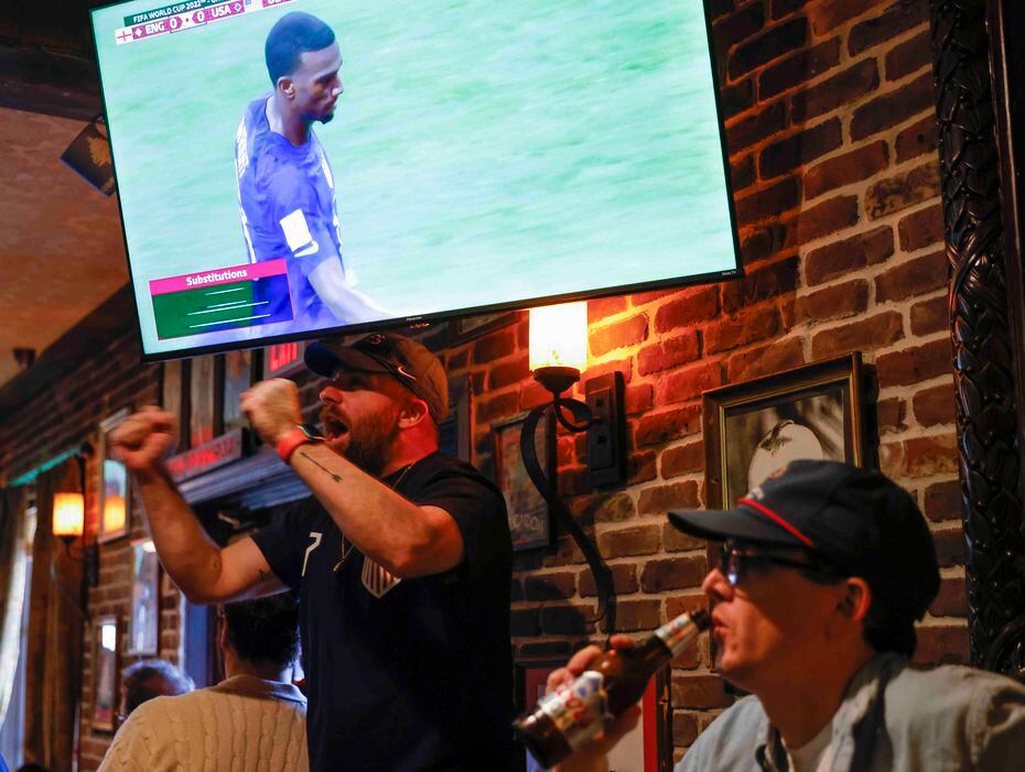 Beau Barnes, left, of Dallas, cheers for USA against England during a World Cup watch party...