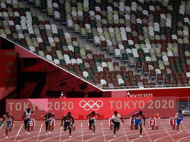 USA’s Fred Kerley (lane 3) and others from heat 5 of 7 race in the 100 meter qualifying race...