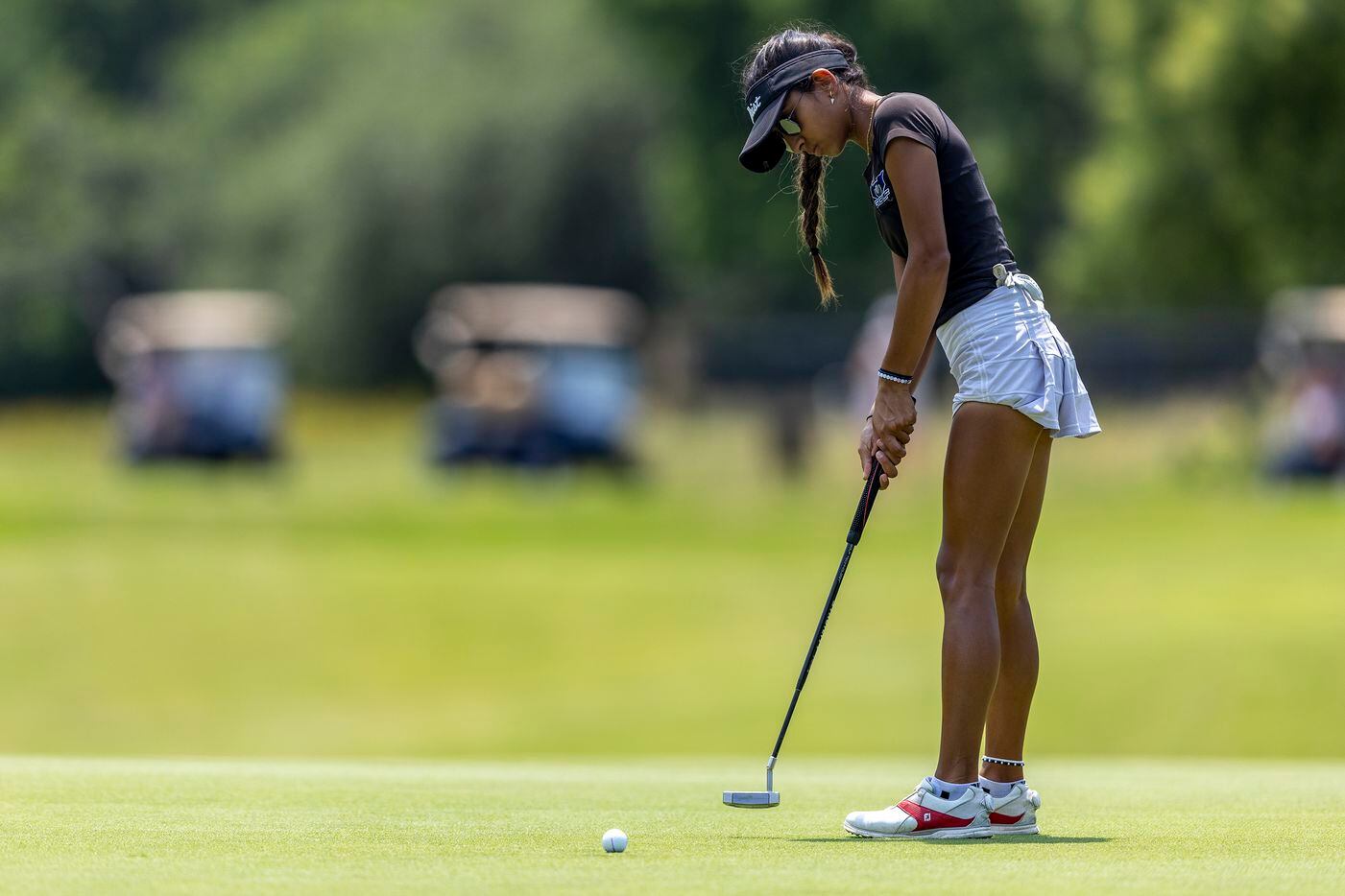 Hebron’s Symran Shah putts on the 8th green during the 6A girls state golf tournament in...