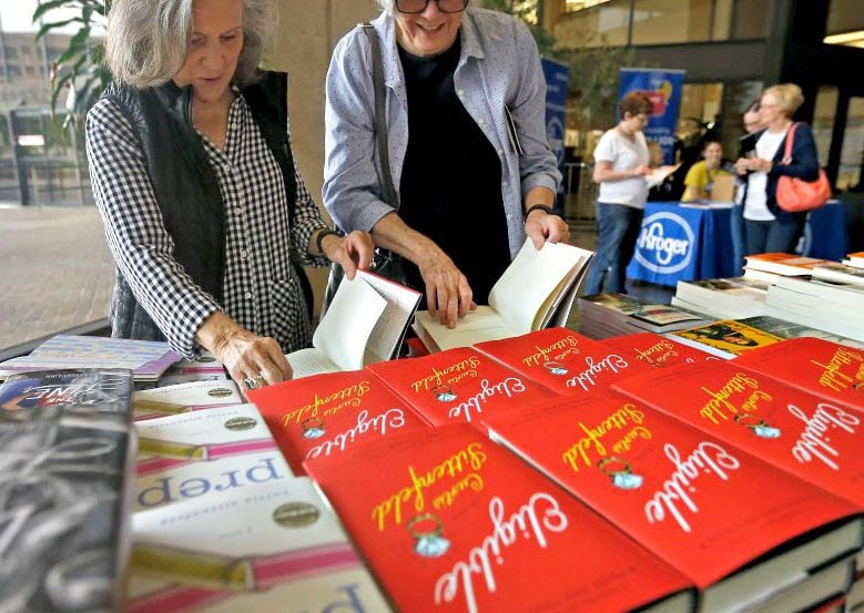 Joyce Dorsey (left) and her friend Jen Carrick take a look at books during the Dallas Book...