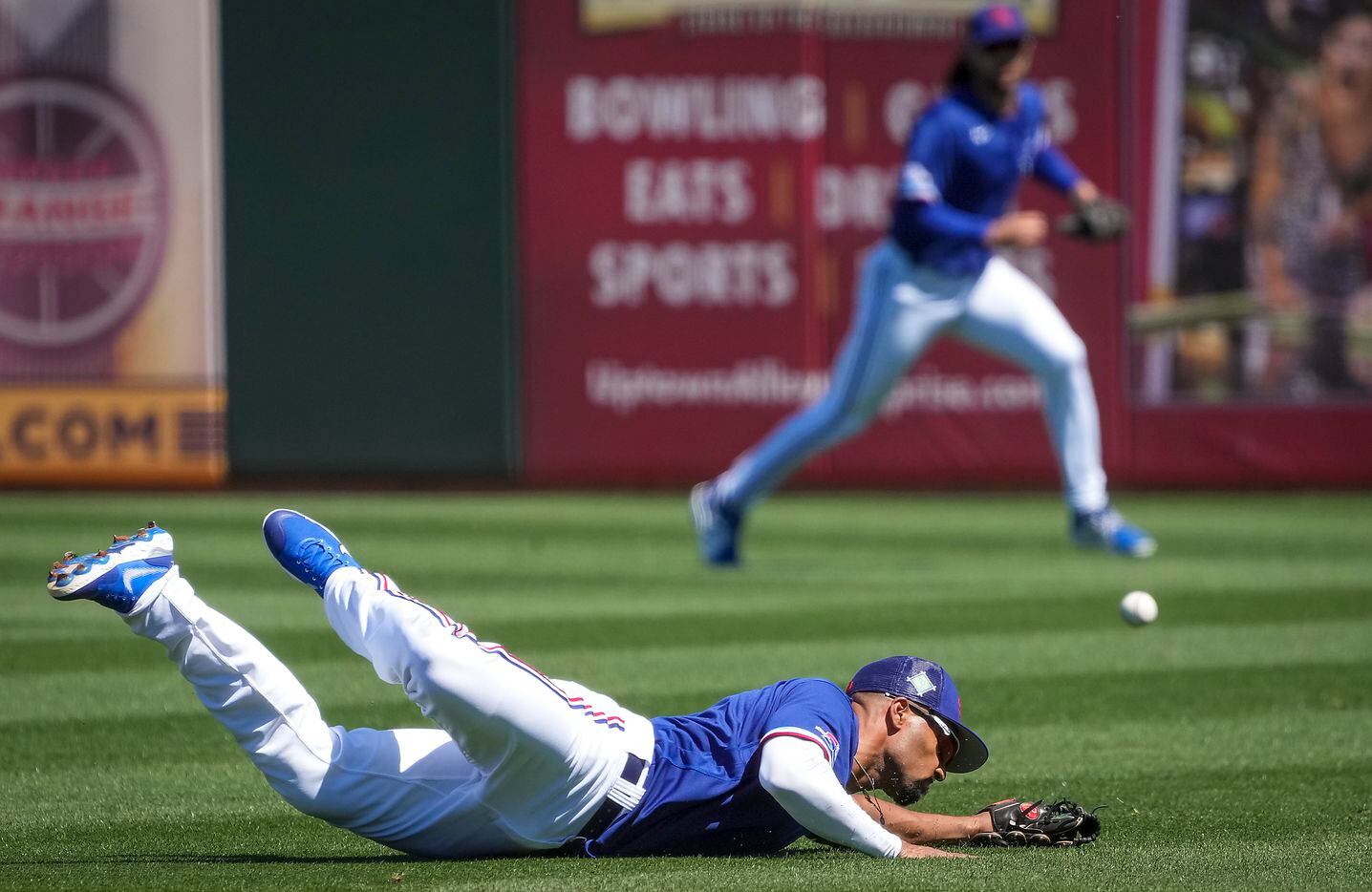 Texas Rangers second baseman Marcus Semien can’t make a diving play on a grounder by Chicago...