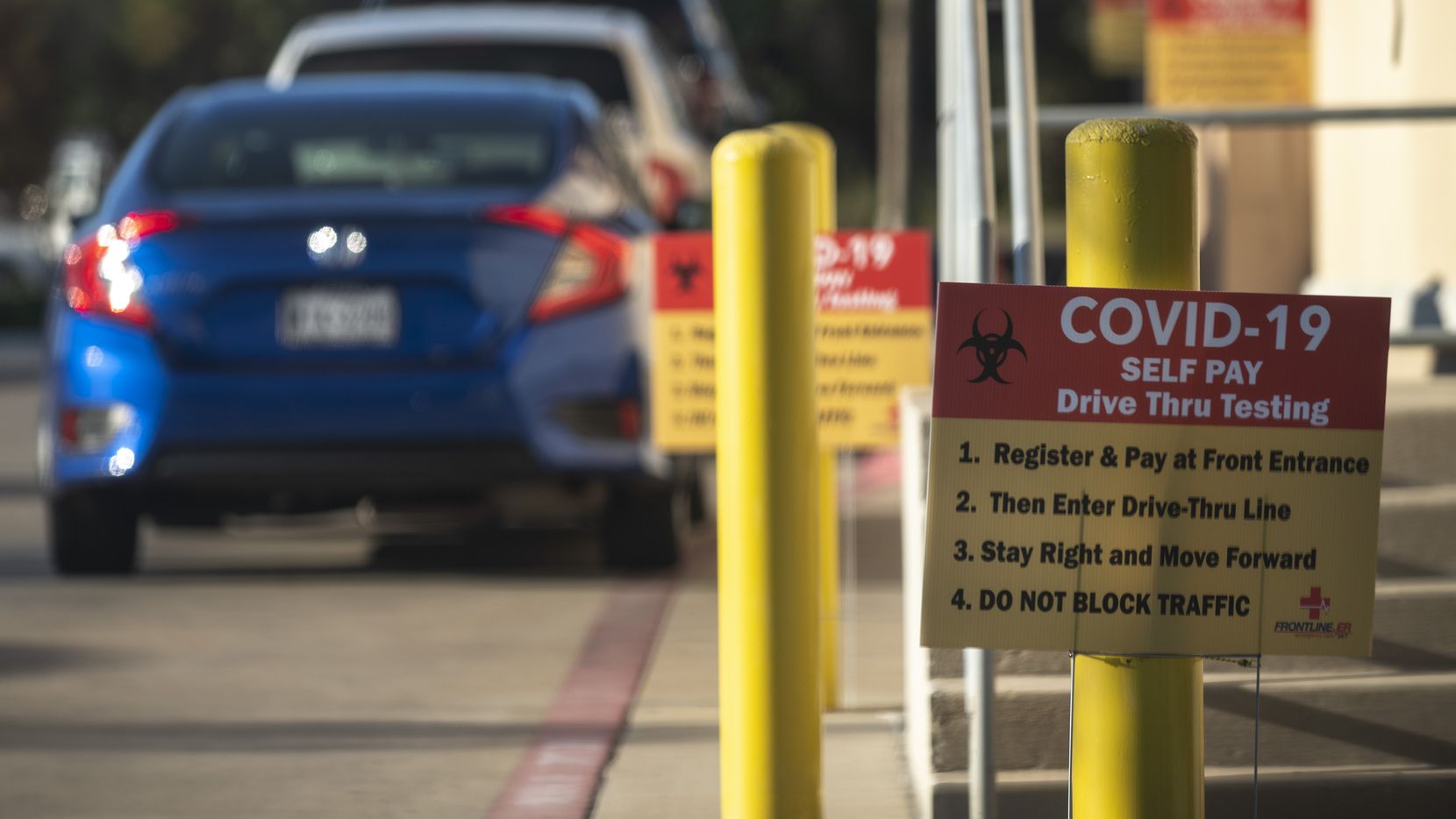Signage for COVID-19 drive-thru testing outside of Frontline ER in Dallas, on Tuesday, Dec....
