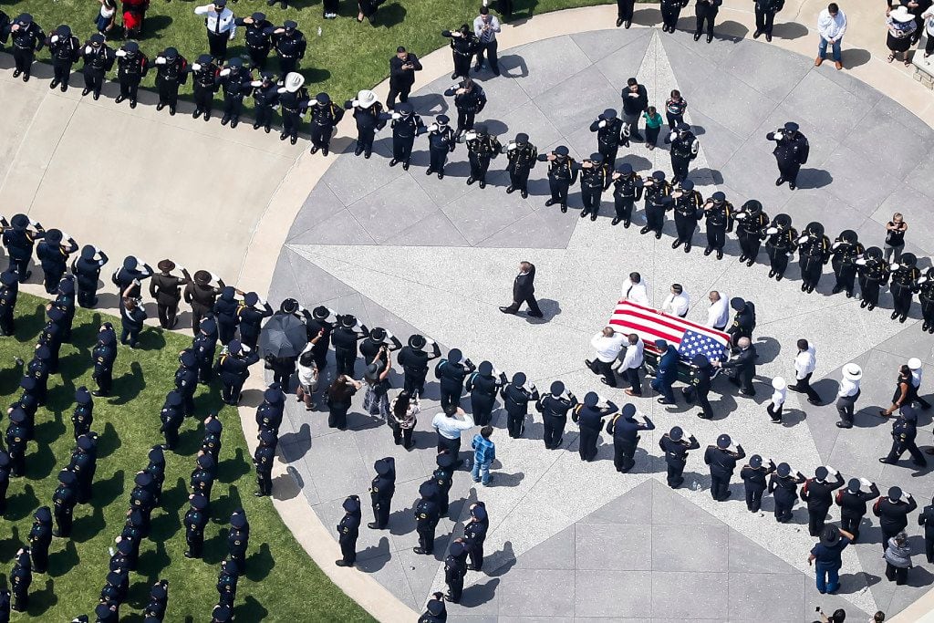 The casket of slain Dallas police officer Patrick Zamarripa is carried by an honor guard...