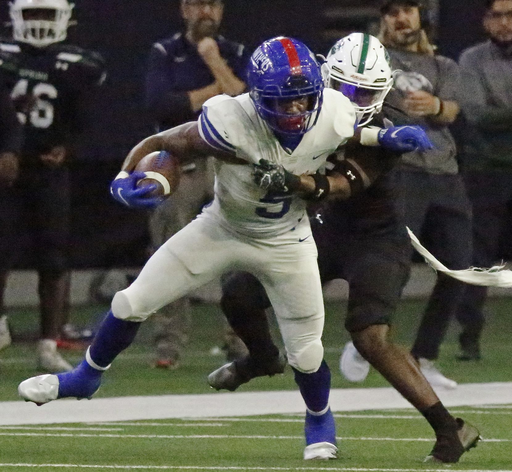 Duncanville High School running back Malachi Medlock (5) is held up by Spring High School defensive back Bruce Davis (6) during the first half as Duncanville High School played Spring High School in a Class 6A Division I Region II semifinal football game at The Ford Center in Frisco on Saturday, November 27, 2021. (Stewart F. House/Special Contributor)