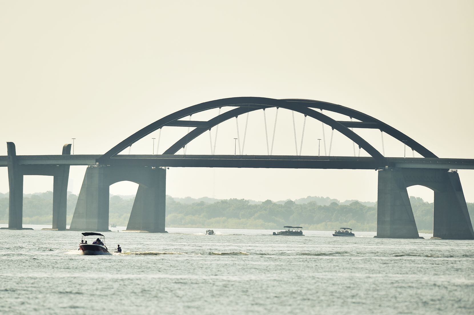 Boaters enjoy the warm sunny weather on Lewisville Lake near the Lewisville Lake toll bridge...