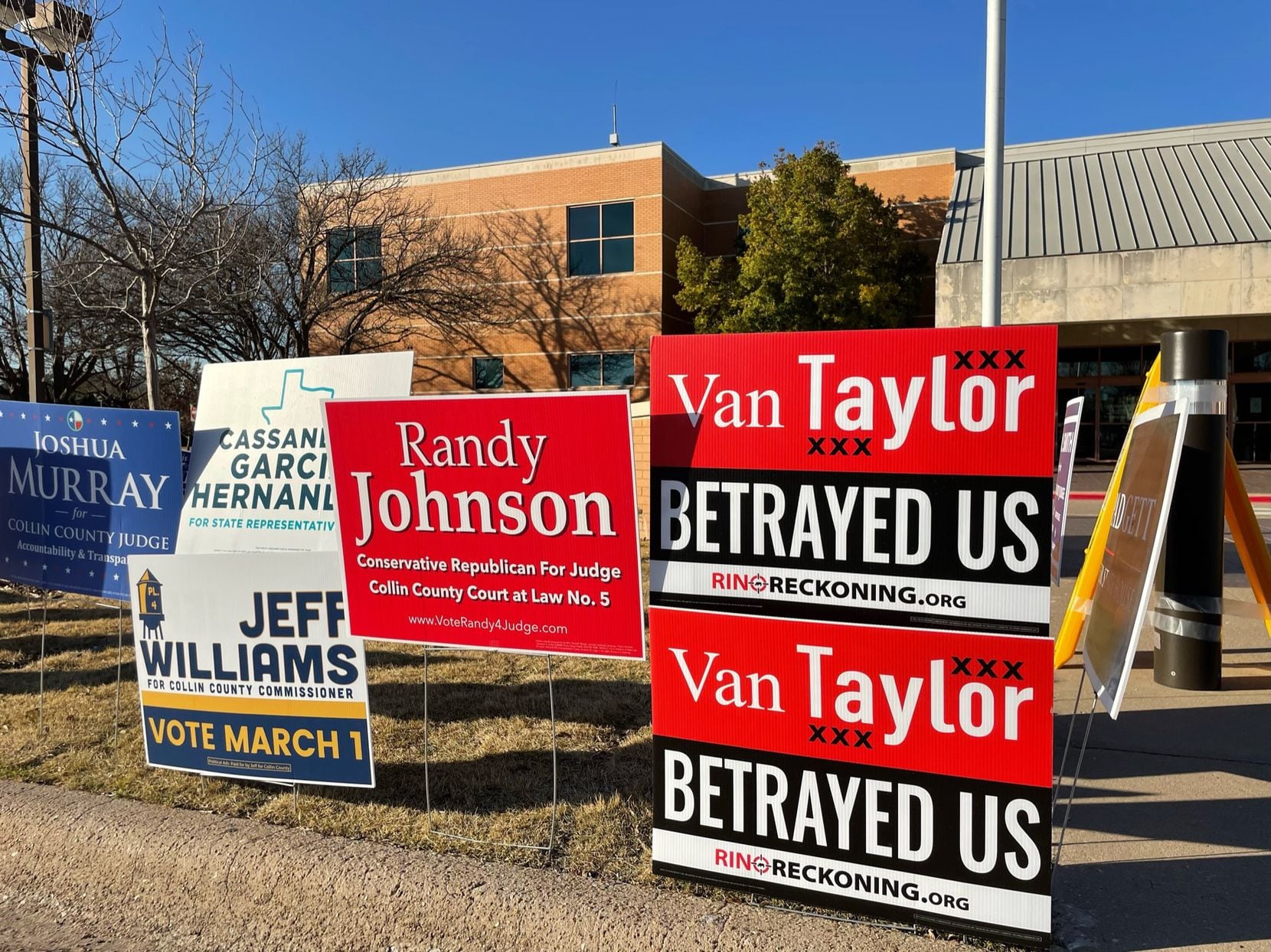 Campaign signs, including signs that read "Van Taylor Betrayed Us" attacking Rep. Van Taylor...