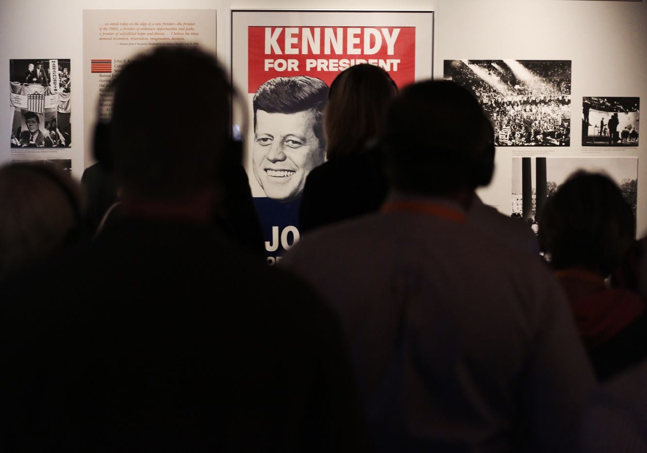 Museum patrons study the history of President John F. Kennedy at the Sixth Floor Museum in...