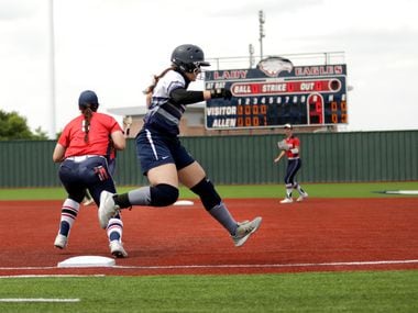 Flower Mound High School player #20, Katie Cantrell, runs past first base during a softball...