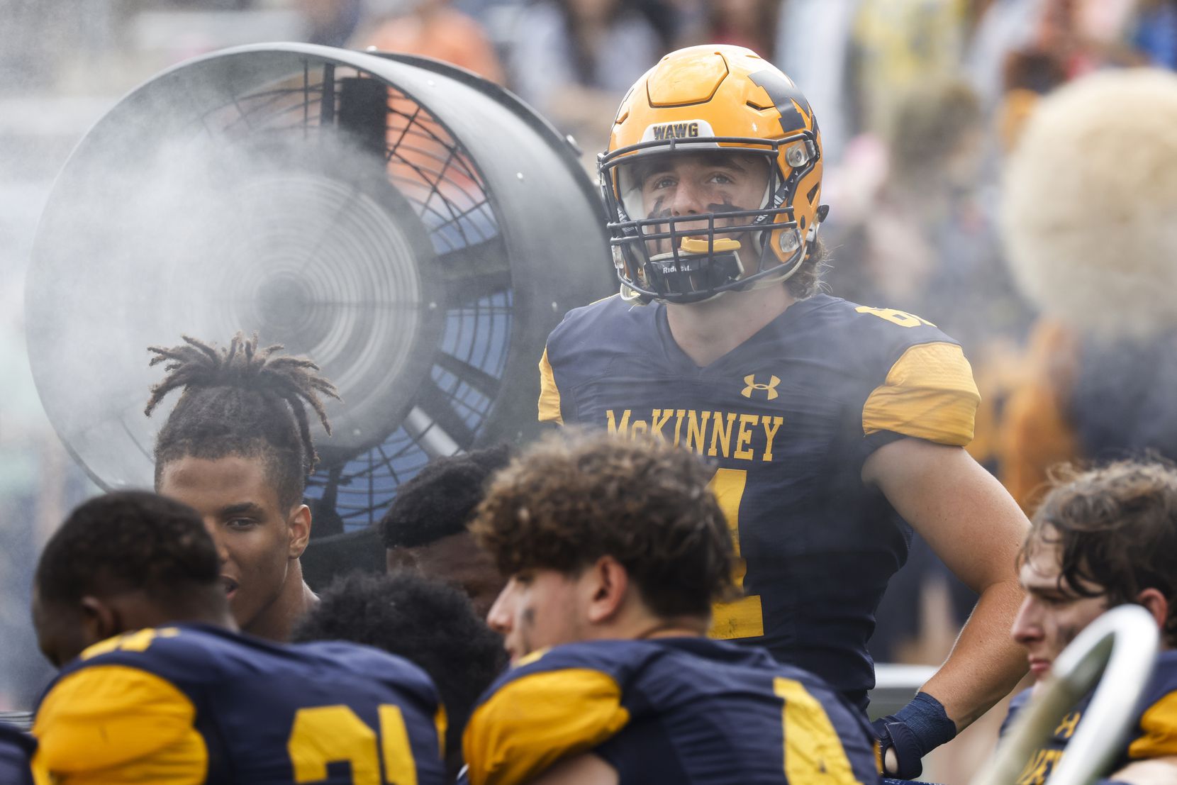 McKinney High players cool off during the second half of a season-opening football game...