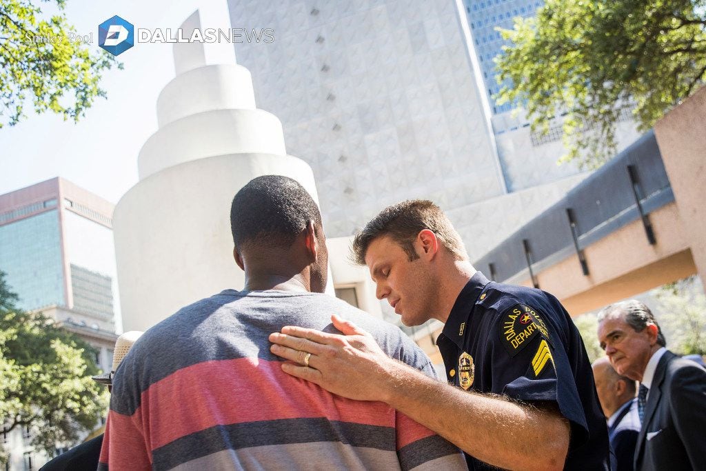 Dallas police Sgt. Dan Mosher comforts Odell Edwards, the father of Jordan Edwards, a...
