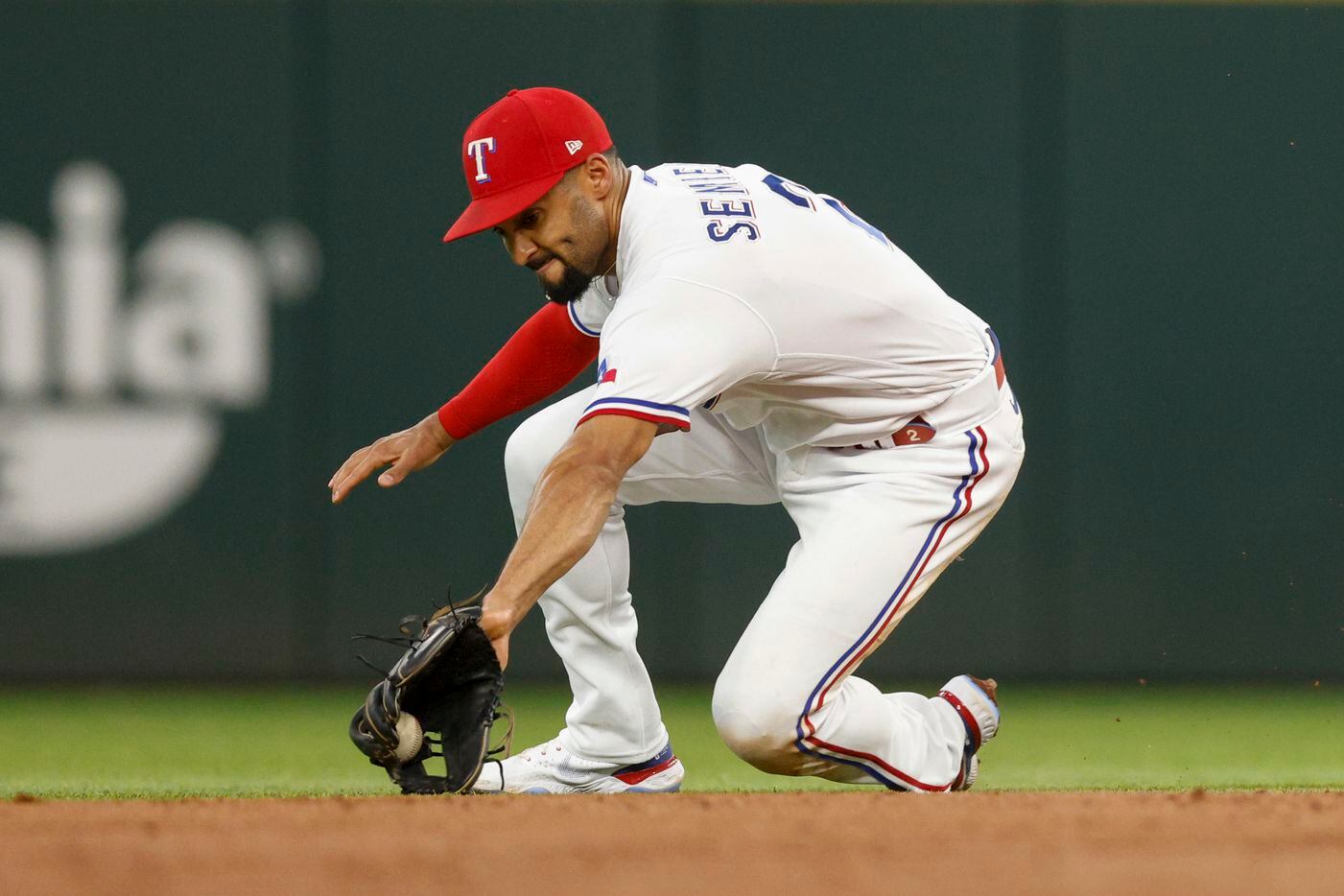 Texas Rangers second baseman Marcus Semien (2) fields the ball for an out during the second...