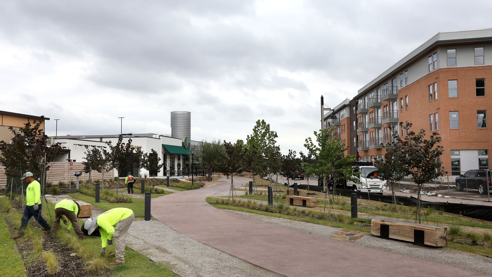 Landscapers work at The Farm in Allen, a mixed use development in Allen. (Jason...