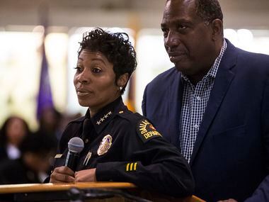 Dallas Police Chief U. Renee Hall and State Senator Royce West listen as people ask...