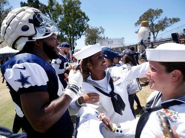 Navy logistics specialists Janisha Stout takes a photo with Dallas Cowboys rookie linebacker...