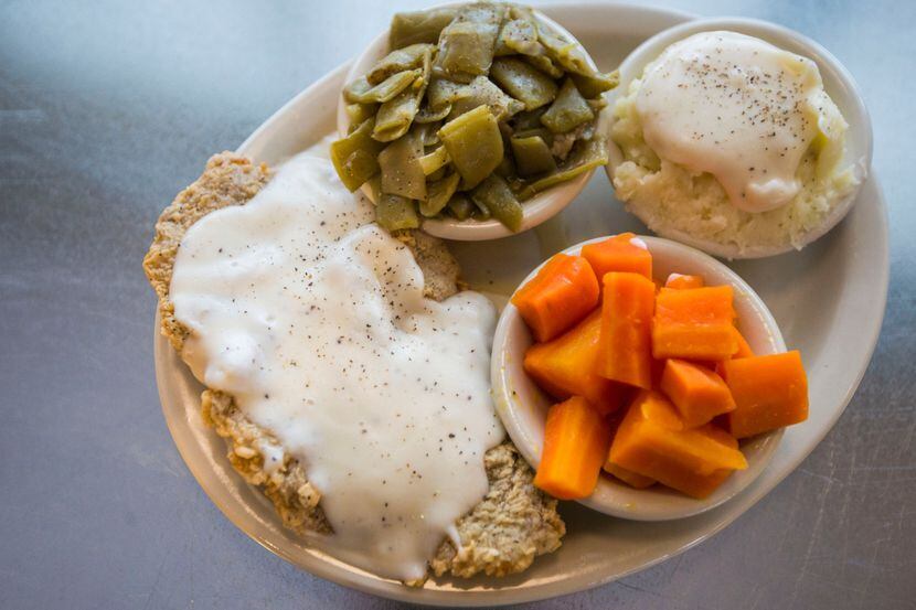 A plate of chicken fried steak and sides. 