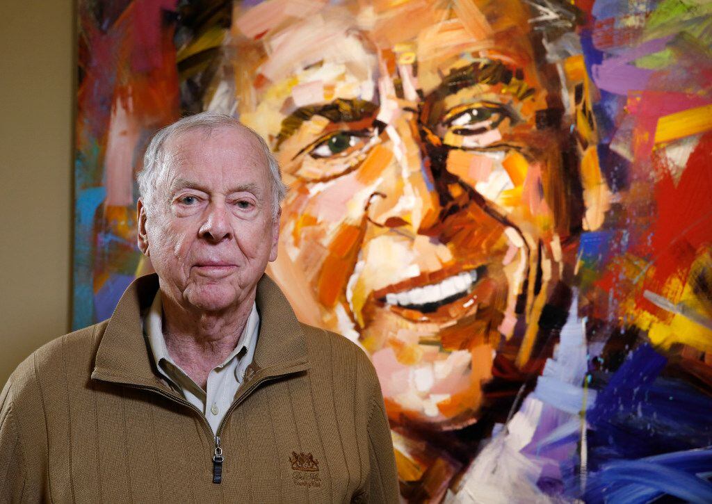 T. Boone Pickens, Chairman and CEO of BP Capital, poses in front of his portrait by Steve...