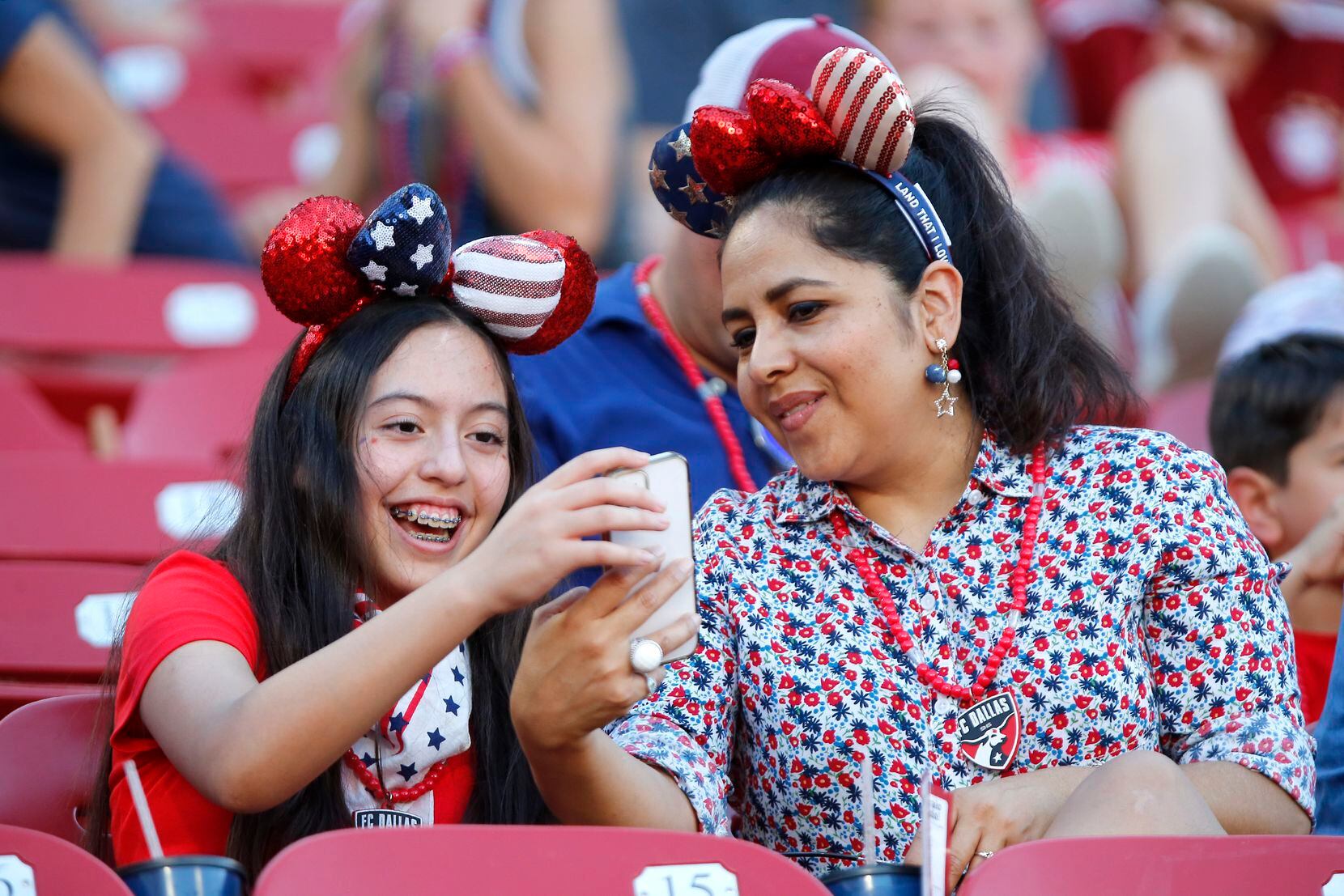Alexa Valles (left), 13, and her mother Ninkosa Valles look at their selfie wearing Fourth...