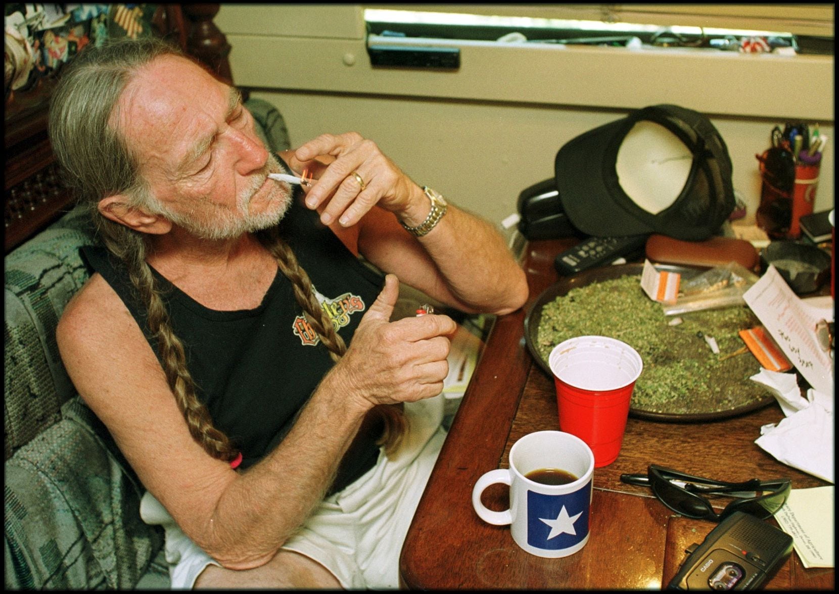Willie Nelson takes a drag off a joint while relaxing at his home in Texas in the 2000s.