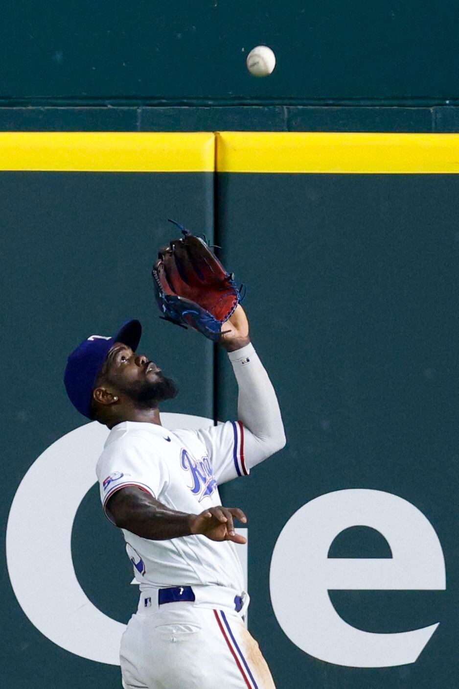 Texas Rangers right fielder Adolis Garcia (53) makes a catch at the wall on a hit by Oakland...