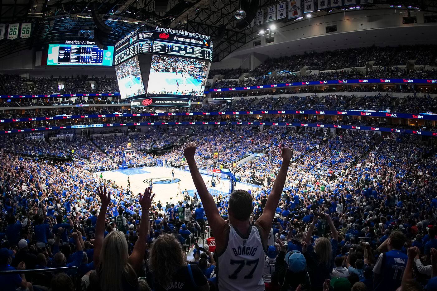 Dallas Mavericks fans cheers a basket during the first half in Game 1 of an NBA first round...